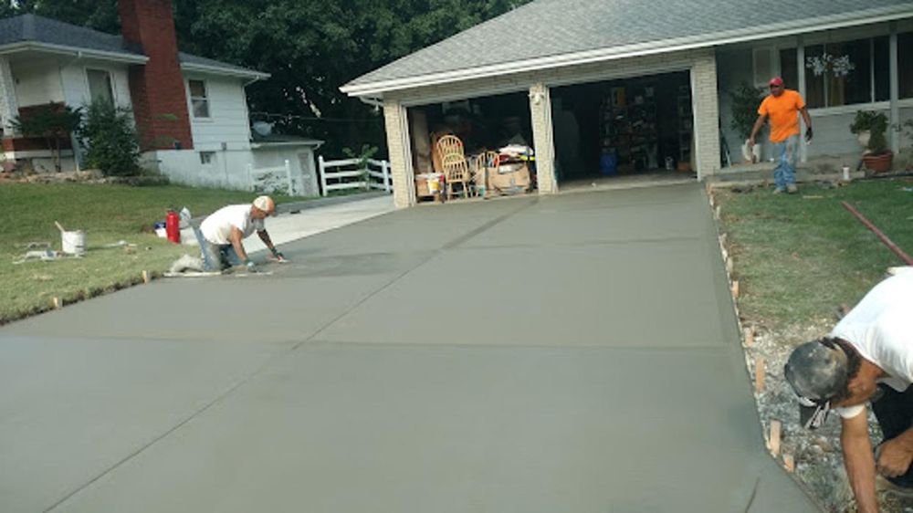 Concrete crew finishing a residential driveway in the Kansas City area
