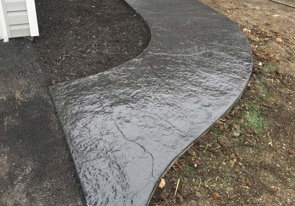 Curved stamped concrete walkway at a Kansas City area property