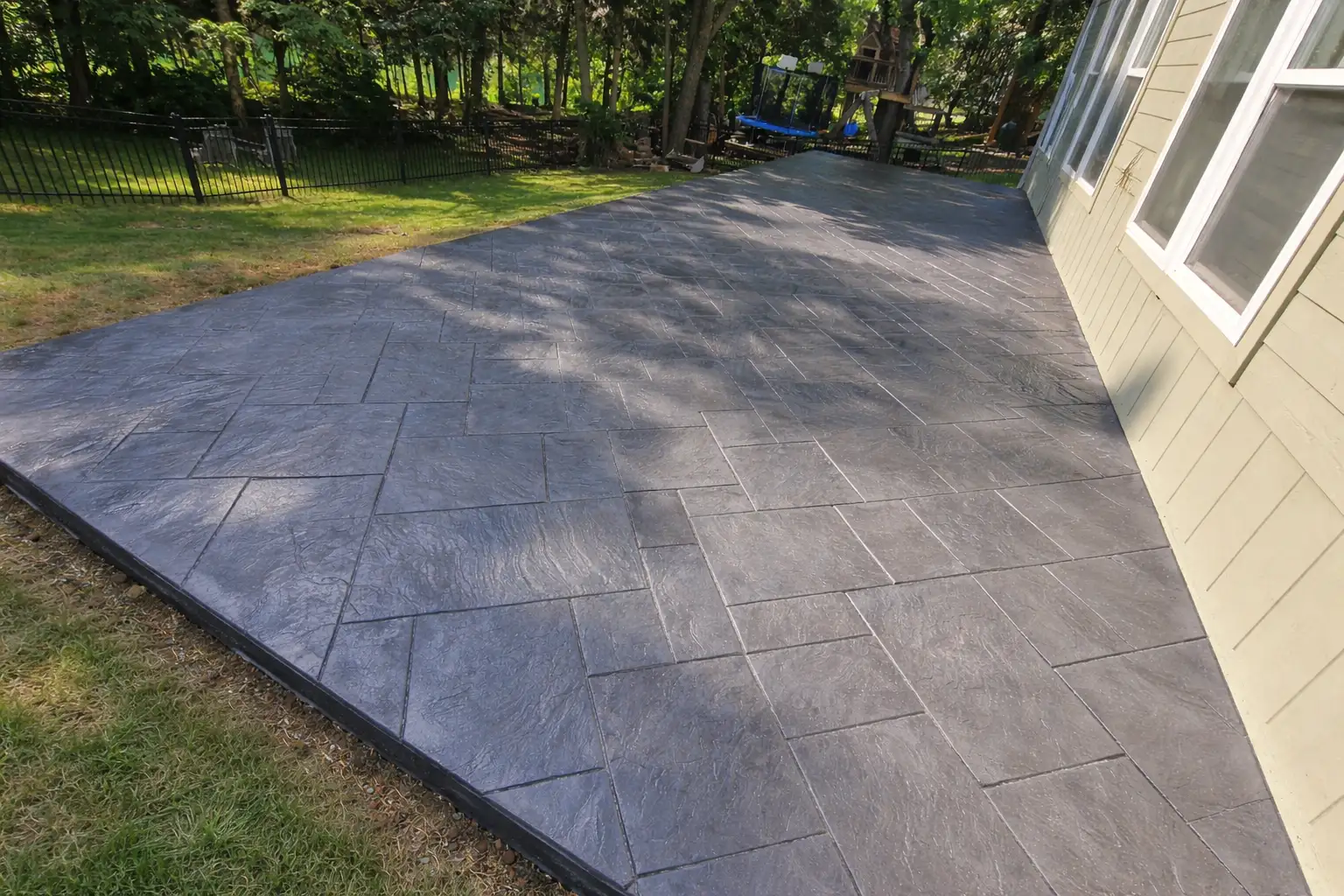 Ashlar slate stamped concrete patio in a Kansas City area backyard